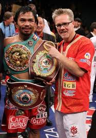 Freddie Roach next to a belt clad Manny Pacquiao