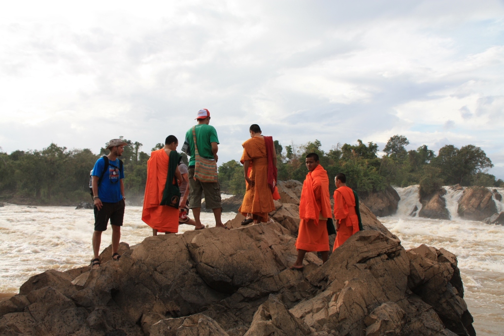 Monks looking at the rapids in the Mekong near Si Phan Don, By: Willem van Gent