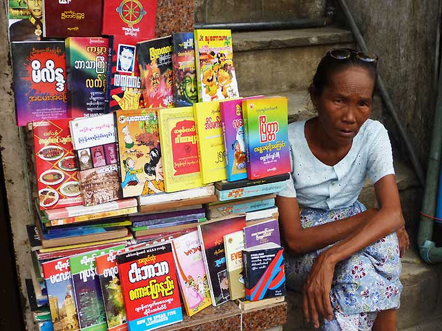 Burmese love to read... but business isn't too brisk for this sidewalk outlet