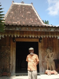 Prayitno in front of a Javanese 'joglo' house at the Setia Darma house of masks