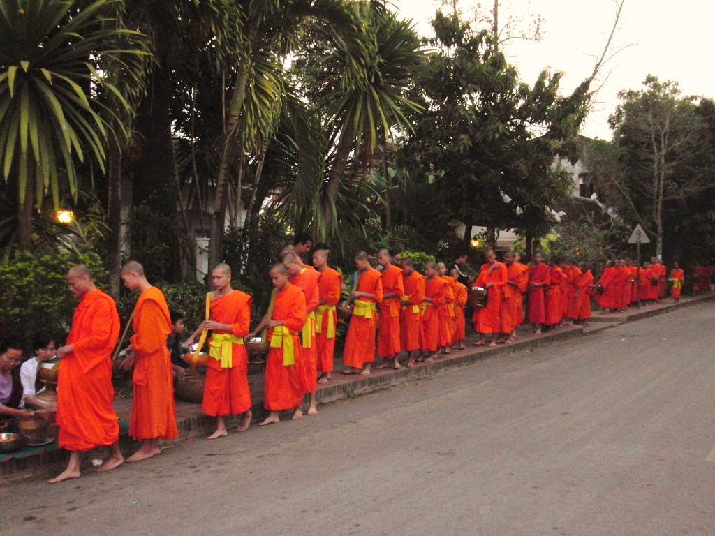 Monks receiving alms, By: Maya Liem 